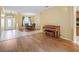 Living room featuring hardwood flooring, a dining table, piano, and foyer entry at 3556 Creek Run Ln, Eustis, FL 32736