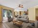 Living room featuring wood floors, neutral decor, and sliding glass doors to patio at 3556 Creek Run Ln, Eustis, FL 32736