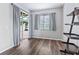 Home office or den with sliding glass doors to patio, laminate floors, and shelving unit at 3556 Creek Run Ln, Eustis, FL 32736