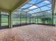 Spacious screened patio with brick pavers, overlooking the backyard at 3556 Creek Run Ln, Eustis, FL 32736