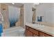 Clean bathroom with shower/tub combo and brown vanity at 4318 St Stephen St, The Villages, FL 32163