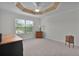 Bright bedroom with carpeted floor, large window, and ceiling fan at 4318 St Stephen St, The Villages, FL 32163