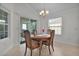Dining room with wooden table, chairs, and access to a lanai at 4318 St Stephen St, The Villages, FL 32163