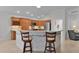 Kitchen with wood cabinets, island, and stainless steel appliances at 4318 St Stephen St, The Villages, FL 32163
