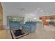Open concept living room with kitchen view and blue couches at 4318 St Stephen St, The Villages, FL 32163