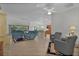 Spacious living room with tile floors and blue couches at 4318 St Stephen St, The Villages, FL 32163