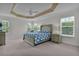 Spacious main bedroom with tray ceiling, ample natural light, and ensuite bathroom at 4318 St Stephen St, The Villages, FL 32163