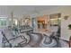 Relaxing sunroom with sliding doors opening to the backyard and view of kitchen at 4318 St Stephen St, The Villages, FL 32163