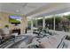 Bright sunroom boasts comfortable seating and large windows, overlooking lush greenery at 4318 St Stephen St, The Villages, FL 32163