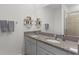 Double vanity bathroom with granite countertops and modern fixtures at 5300 Sunshine Dr, Wildwood, FL 34785