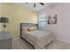 Bright bedroom with a full bed, accent wall, and neutral decor at 5300 Sunshine Dr, Wildwood, FL 34785