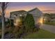 Charming single-story home with a welcoming front entrance and landscaped yard at sunset at 5300 Sunshine Dr, Wildwood, FL 34785