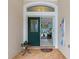 Front entryway with a green door, arched window, and welcome sign at 5318 Greens Dr, Lady Lake, FL 32159