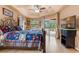 Large main bedroom with wood floors, ceiling fan, and patio access at 5318 Greens Dr, Lady Lake, FL 32159