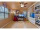 Home office with wood floors, built-in shelves, and two computer monitors at 5318 Greens Dr, Lady Lake, FL 32159