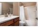 Clean bathroom with shower/tub combo, toilet and vanity at 5806 Woodland Moss Way, Leesburg, FL 34748