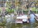 Private boat dock with covered structure and lift at 6356 Sailboat Ave, Tavares, FL 32778