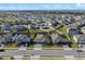 Aerial view of a new home community with numerous houses and a large green space at 771 Annabell Ridge Rd, Minneola, FL 34715