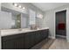 Elegant bathroom with double vanity, large mirror, and a walk-in shower at 771 Annabell Ridge Rd, Minneola, FL 34715