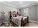 Charming bedroom with an ornate bed frame and neutral decor at 771 Annabell Ridge Rd, Minneola, FL 34715