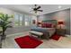 Spacious bedroom with large windows, ceiling fan, and wood furniture at 771 Annabell Ridge Rd, Minneola, FL 34715