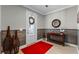 Bright entryway with red rug, wood-look walls, and decorative accents at 771 Annabell Ridge Rd, Minneola, FL 34715