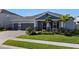 Two-story home with gray siding, red accents, and a lush lawn at 771 Annabell Ridge Rd, Minneola, FL 34715
