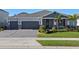 Two-story home with gray siding, red accents, and a lush lawn at 771 Annabell Ridge Rd, Minneola, FL 34715