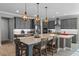 Modern kitchen with gray cabinets, large island, and stainless steel appliances at 771 Annabell Ridge Rd, Minneola, FL 34715