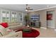 Living room with sectional sofa, coffee table, and large TV at 771 Annabell Ridge Rd, Minneola, FL 34715