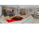 Living room with sectional sofa, bar area, and large TV at 771 Annabell Ridge Rd, Minneola, FL 34715