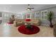 Spacious living area with large sectional sofa and red rug at 771 Annabell Ridge Rd, Minneola, FL 34715