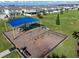 Community playground with swings and play structures under a shade sail at 771 Annabell Ridge Rd, Minneola, FL 34715