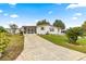 Home with paved driveway and landscaping at 811 Saint Andrews Blvd, The Villages, FL 32159