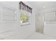 Clean bathroom with shower, window, and white tile flooring at 9199 Se 171St Cooper Loop, The Villages, FL 32162