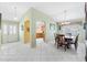 Dining area with wooden table and chairs, view of kitchen at 9199 Se 171St Cooper Loop, The Villages, FL 32162
