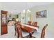 Bright dining room with wooden table, chairs, and view of living room at 9199 Se 171St Cooper Loop, The Villages, FL 32162
