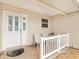 Front entrance with white door and two-striped chairs at 9199 Se 171St Cooper Loop, The Villages, FL 32162