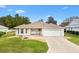 Single-story house with attached garage and landscaped lawn at 9199 Se 171St Cooper Loop, The Villages, FL 32162