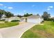 Front view of house with driveway and yard at 9199 Se 171St Cooper Loop, The Villages, FL 32162