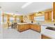 Bright kitchen with oak cabinets, ample counter space, and a breakfast nook at 9199 Se 171St Cooper Loop, The Villages, FL 32162