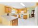 Modern kitchen features oak cabinets and breakfast bar at 9199 Se 171St Cooper Loop, The Villages, FL 32162
