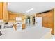 Spacious kitchen with oak cabinets, white appliances, and an island at 9199 Se 171St Cooper Loop, The Villages, FL 32162