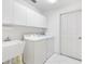 Laundry room with washer, dryer, and cabinets at 9199 Se 171St Cooper Loop, The Villages, FL 32162