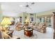 Spacious living room with floral sofas, coffee table, and large windows at 9199 Se 171St Cooper Loop, The Villages, FL 32162