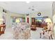 Living room with floral sofa, coffee table and large TV at 9199 Se 171St Cooper Loop, The Villages, FL 32162