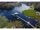 Aerial view of a peaceful waterfront community with boats and docks at 934 Belle Oak Dr, Leesburg, FL 34748