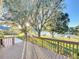 Deck with lake view, surrounded by lush greenery at 9835 Lakeshore Dr, Clermont, FL 34711