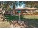 Ranch style home with a large backyard, deck, and mature tree at 9835 Lakeshore Dr, Clermont, FL 34711