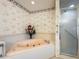 Bathroom with corner bathtub and shower at 9835 Lakeshore Dr, Clermont, FL 34711